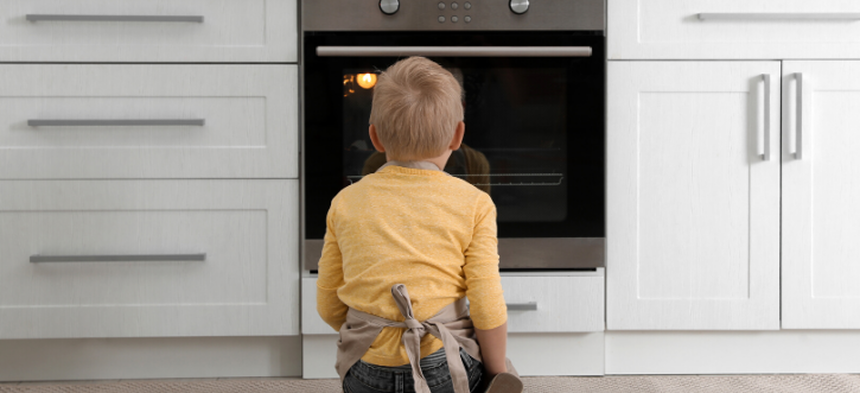 Kid looking in oven