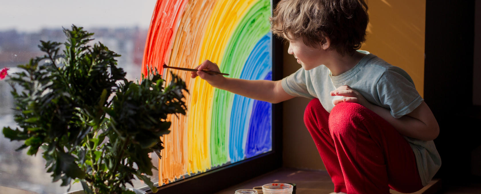 Boy painting rainbow