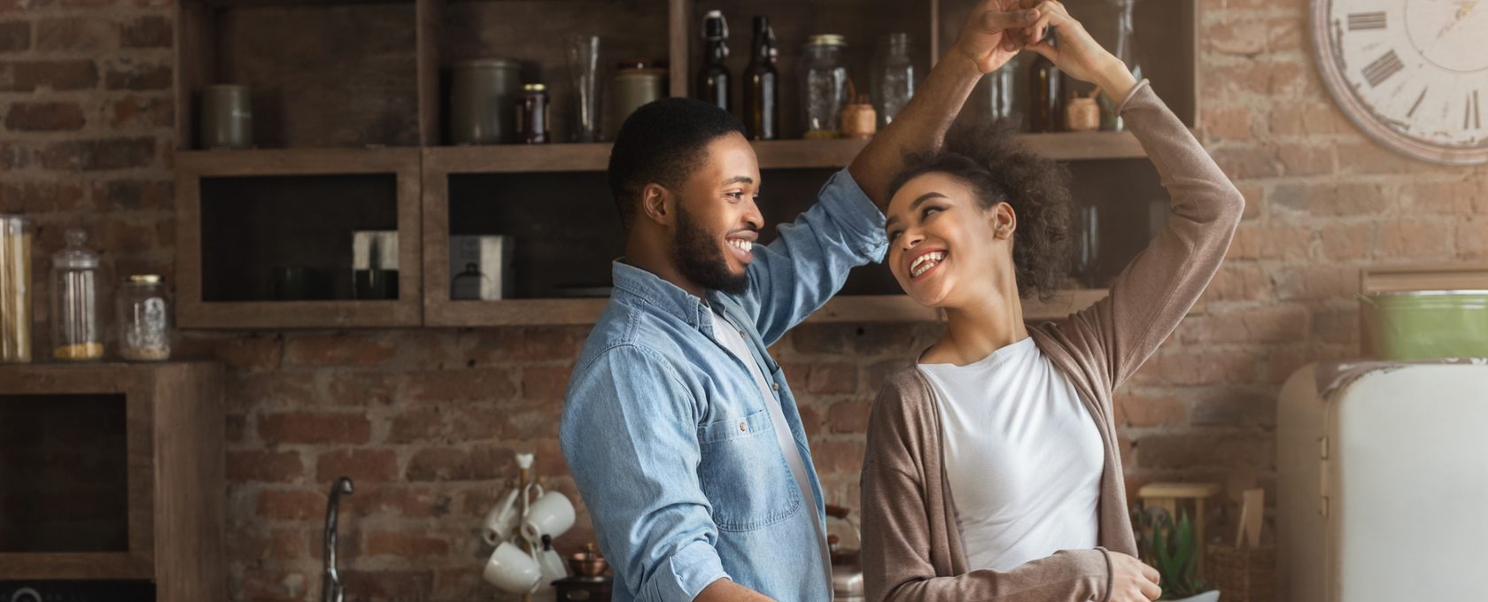 Couple dancing while cooking