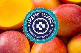 Blue and teal logo for the "FARE PACT Alliance" over an assortment of ripe mangoes.