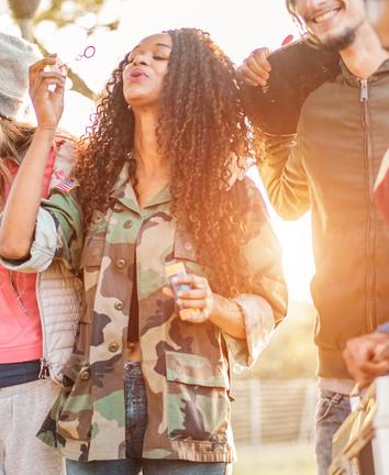 young adults blowing bubbles