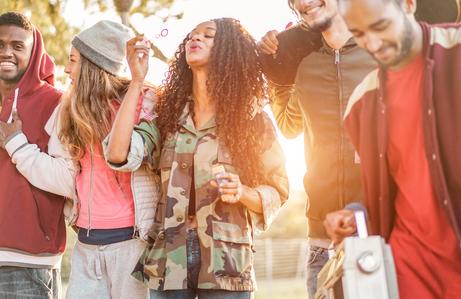 young adults blowing bubbles