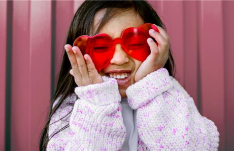 girl wearing heart glasses