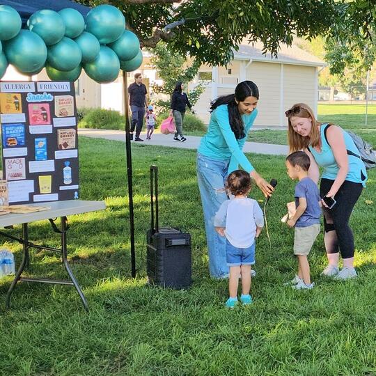 Child speaks into microphone at Hometown Heroes Walk