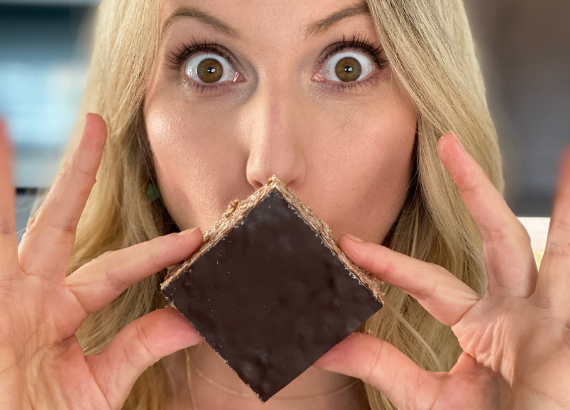 Leslie holding up an OWYN chocolate rice crispy treat