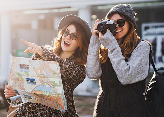 Friends looking at a map and using a camera