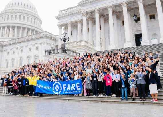 FARE advocates holding a sign that says "We are FARE" in front of the Capitol