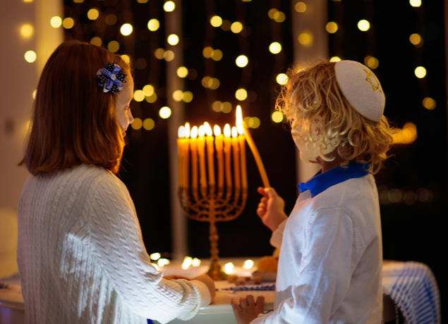 Kids lighting Menorah