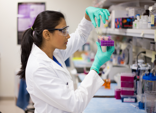 Woman looking at test tubes